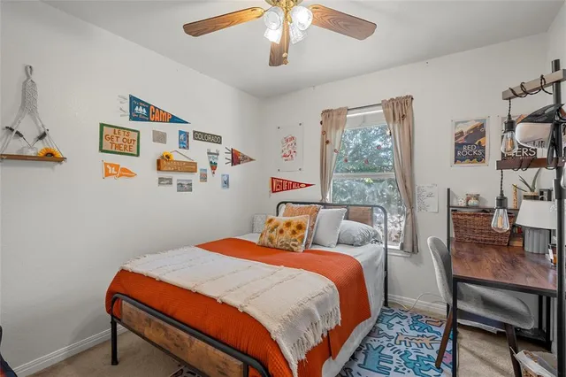 a bathroom with a granite countertop sink a toilet and mirror