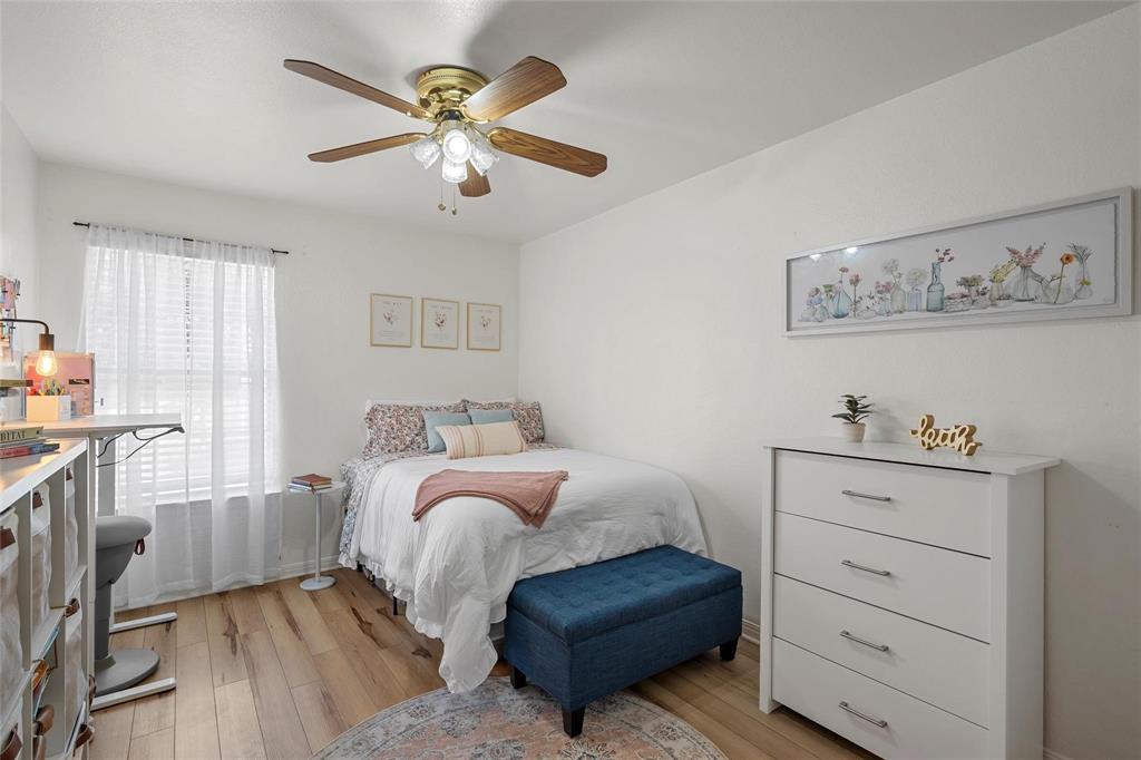 1915 South 7th Street Waco, TX 76706 - Photo 21 of 40 a bedroom with a bed and a chandelier