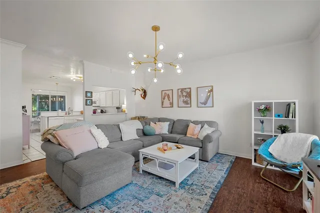 a living room with furniture and a chandelier
