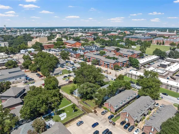 an aerial view of a house with a yard and plants