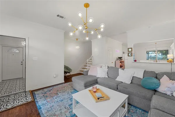 a living room with furniture and a chandelier