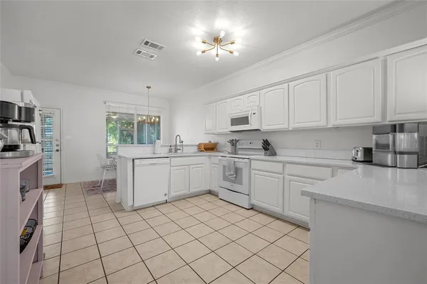 a kitchen with a sink cabinets and window