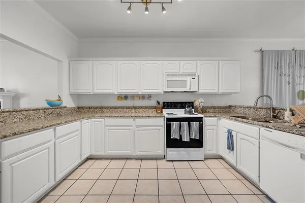 a kitchen with a sink stove and cabinets