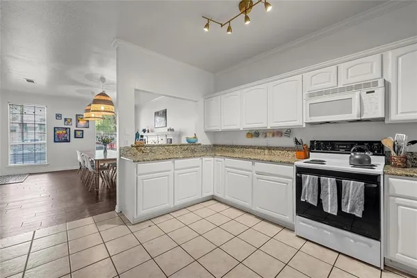 a kitchen with a white cabinets and white appliances