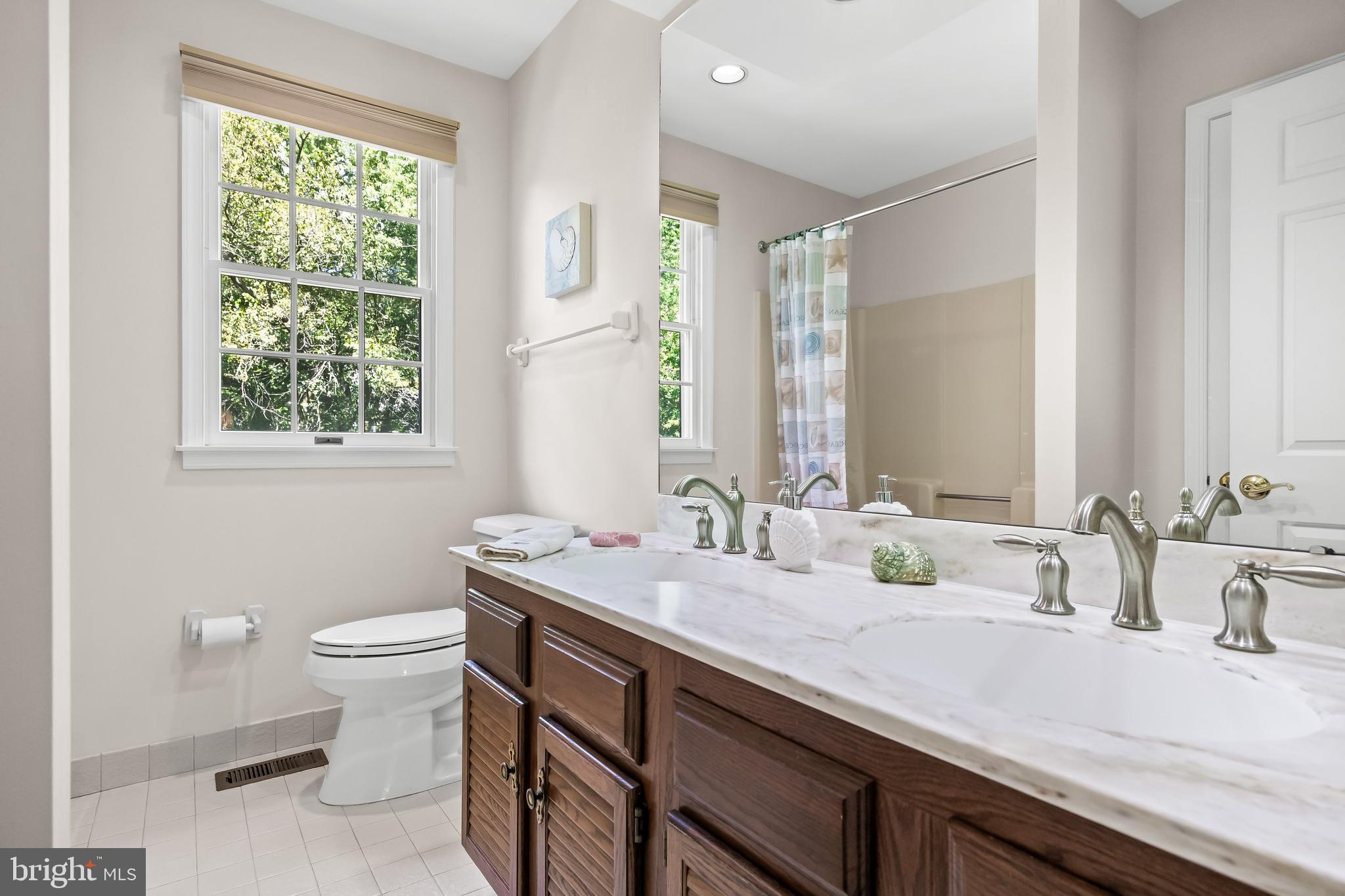 803 Fernwood Road Moorestown, NJ 08057 - Photo 34 of 46 a bathroom with a double vanity sink toilet and a mirror