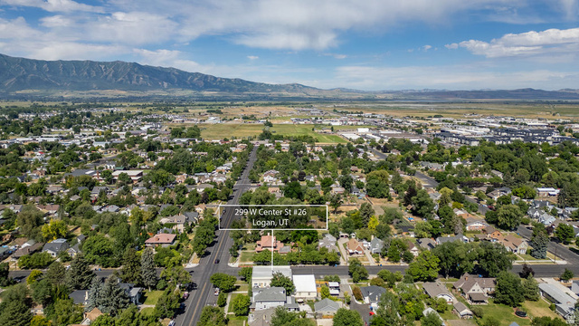299 West Center Street, Unit 2 Logan, UT 84321 - Photo 44 of 46 Aerial perspective showcasing a residential neighborhood with a prominent mountain range backdrop