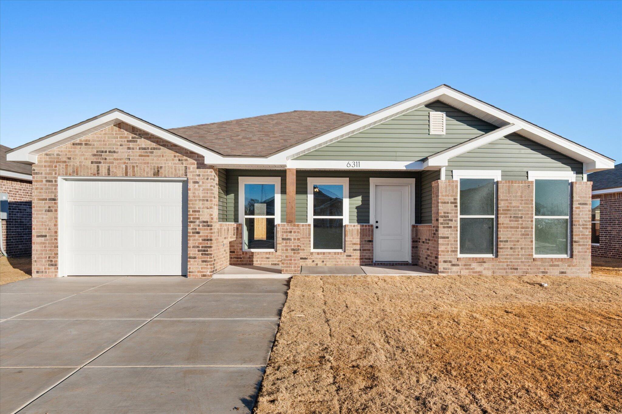 6311 Volney Avenue Lubbock, TX 79407 - Photo 1 of 23 a front view of a house with a garden and entryway