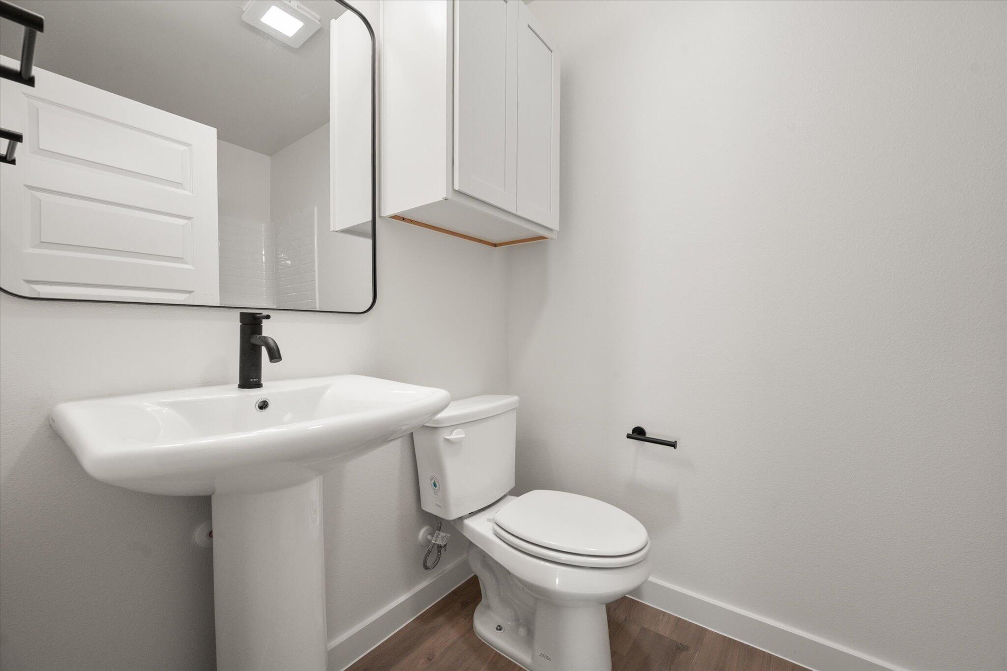 6311 Volney Avenue Lubbock, TX 79407 - Photo 19 of 23 a bathroom with a sink a toilet and mirror