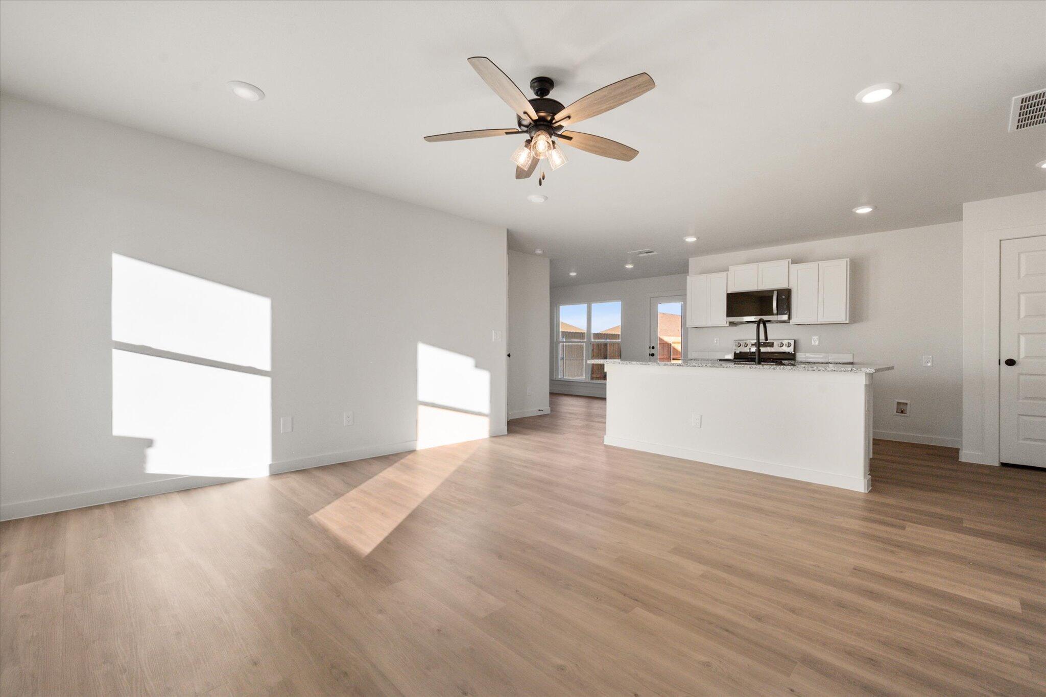 6311 Volney Avenue Lubbock, TX 79407 - Photo 3 of 23 a view of a kitchen with a sink and a window