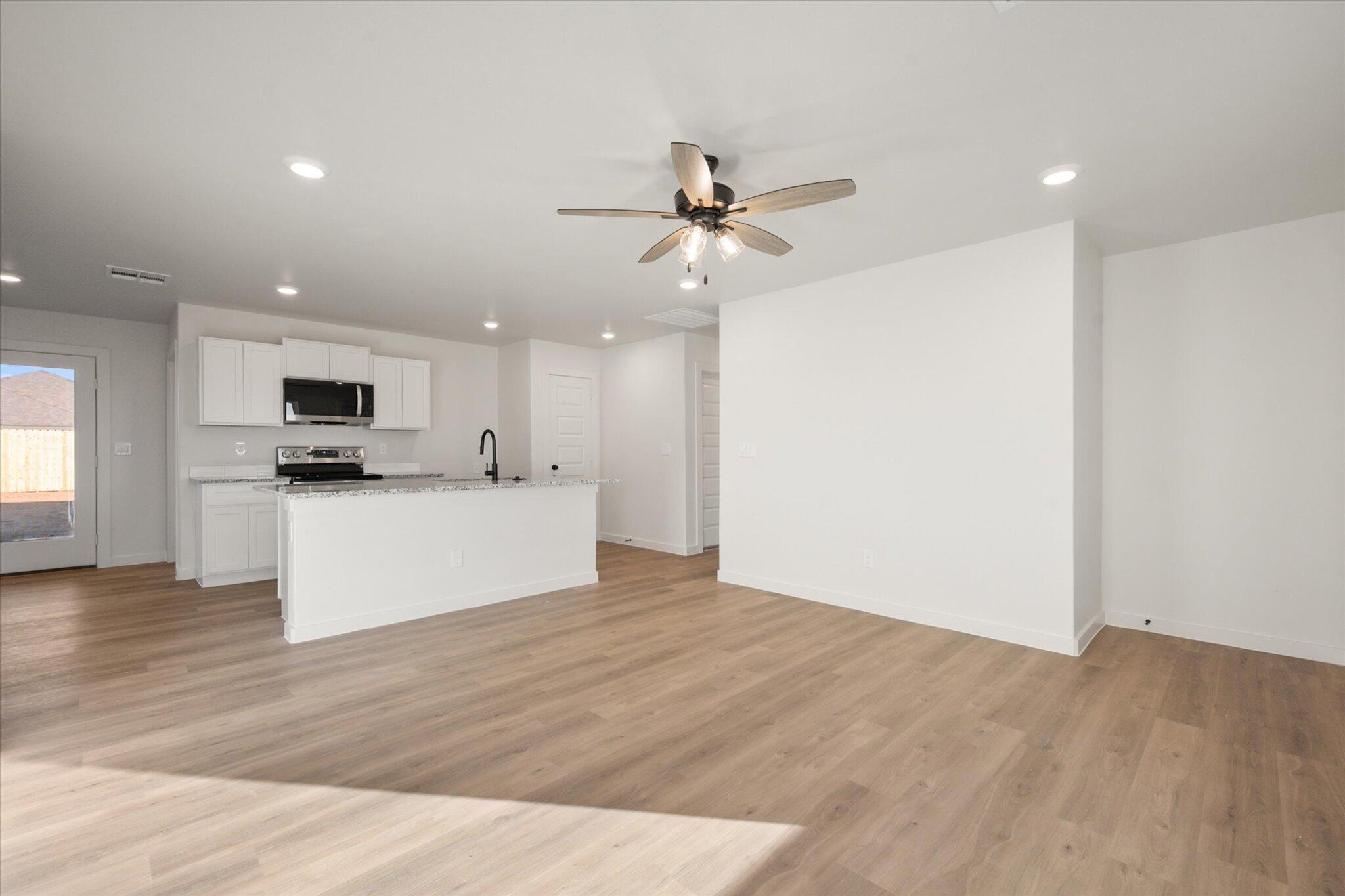 6311 Volney Avenue Lubbock, TX 79407 - Photo 4 of 23 a view of kitchen with stainless steel appliances kitchen island a refrigerator sink and microwave