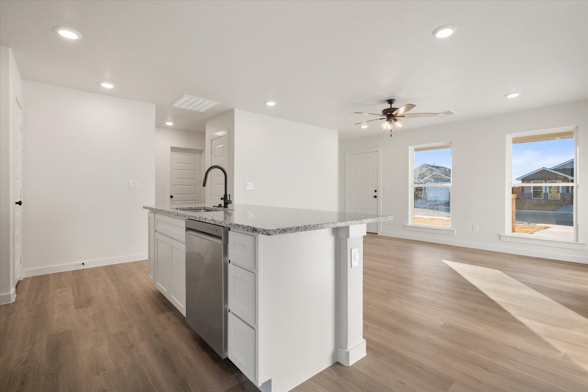 6311 Volney Avenue Lubbock, TX 79407 - Photo 10 of 23 a kitchen with kitchen island a sink and wooden floor