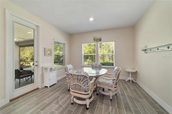 a dining room with furniture and wooden floor