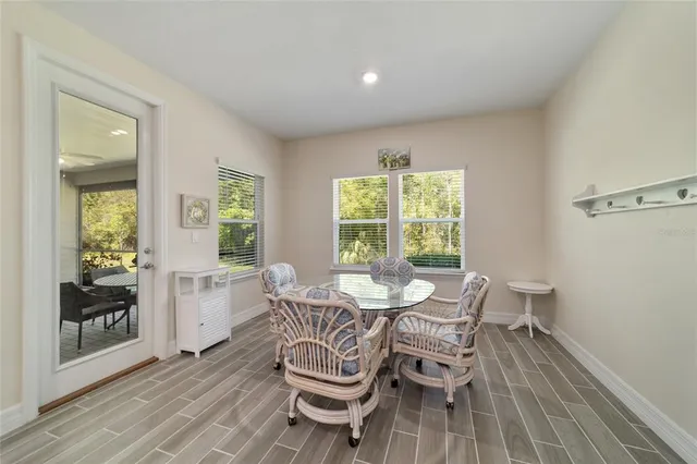 a dining room with furniture and wooden floor