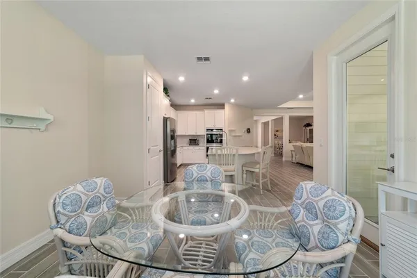 a living room with furniture and a dining table with kitchen view
