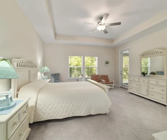 a bedroom with bed and a chandelier