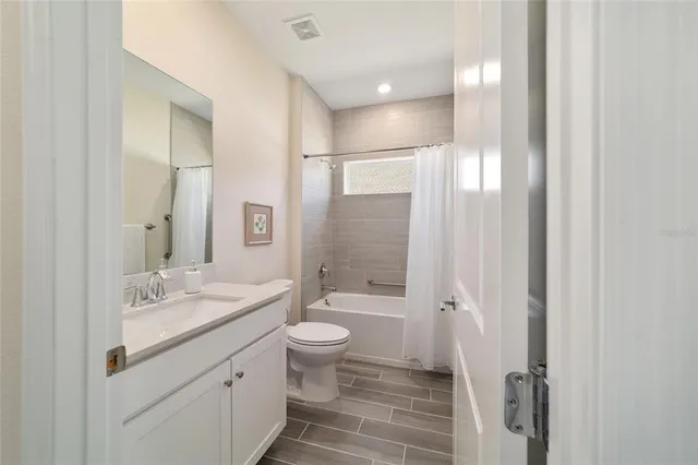 a room with a bed and a chandelier