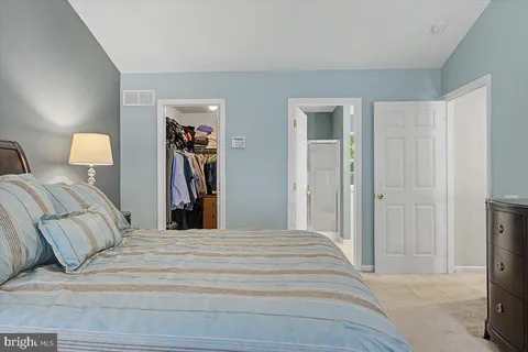 a bedroom with a bed and a walk in closet