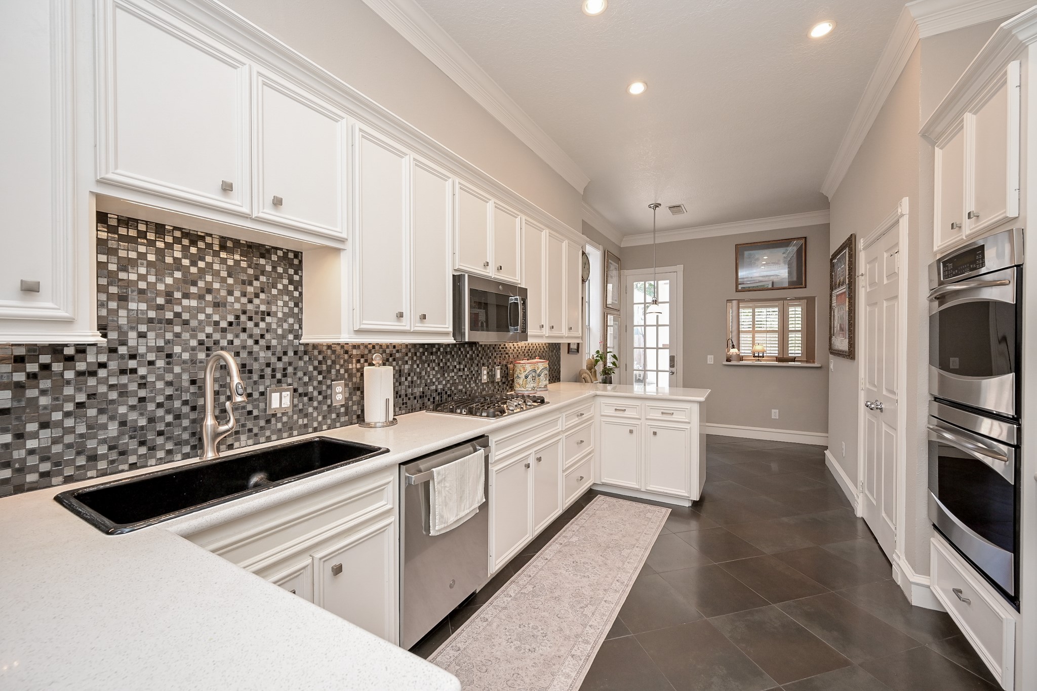 2301 Steel Street Houston, TX 77098 - Photo 11 of 34 Kitchen with breakfast bar, stainless steel appliances, tile flooring and backsplash.