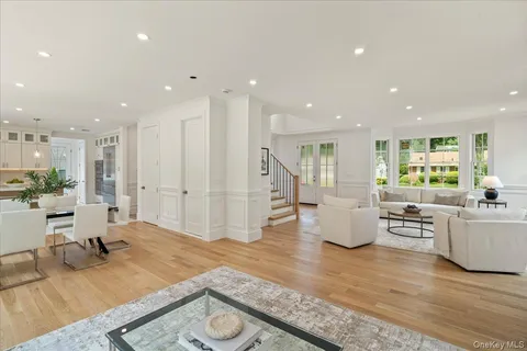 a living room with fireplace furniture and a wooden floor