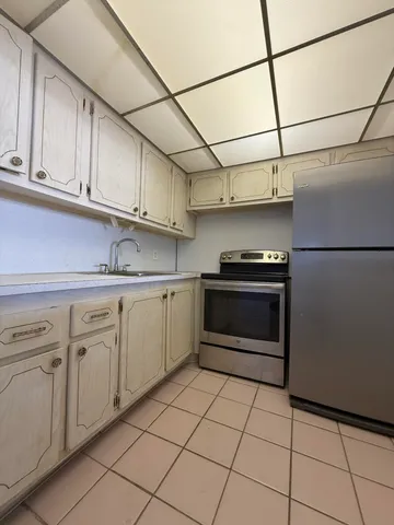 a kitchen with cabinets and appliances