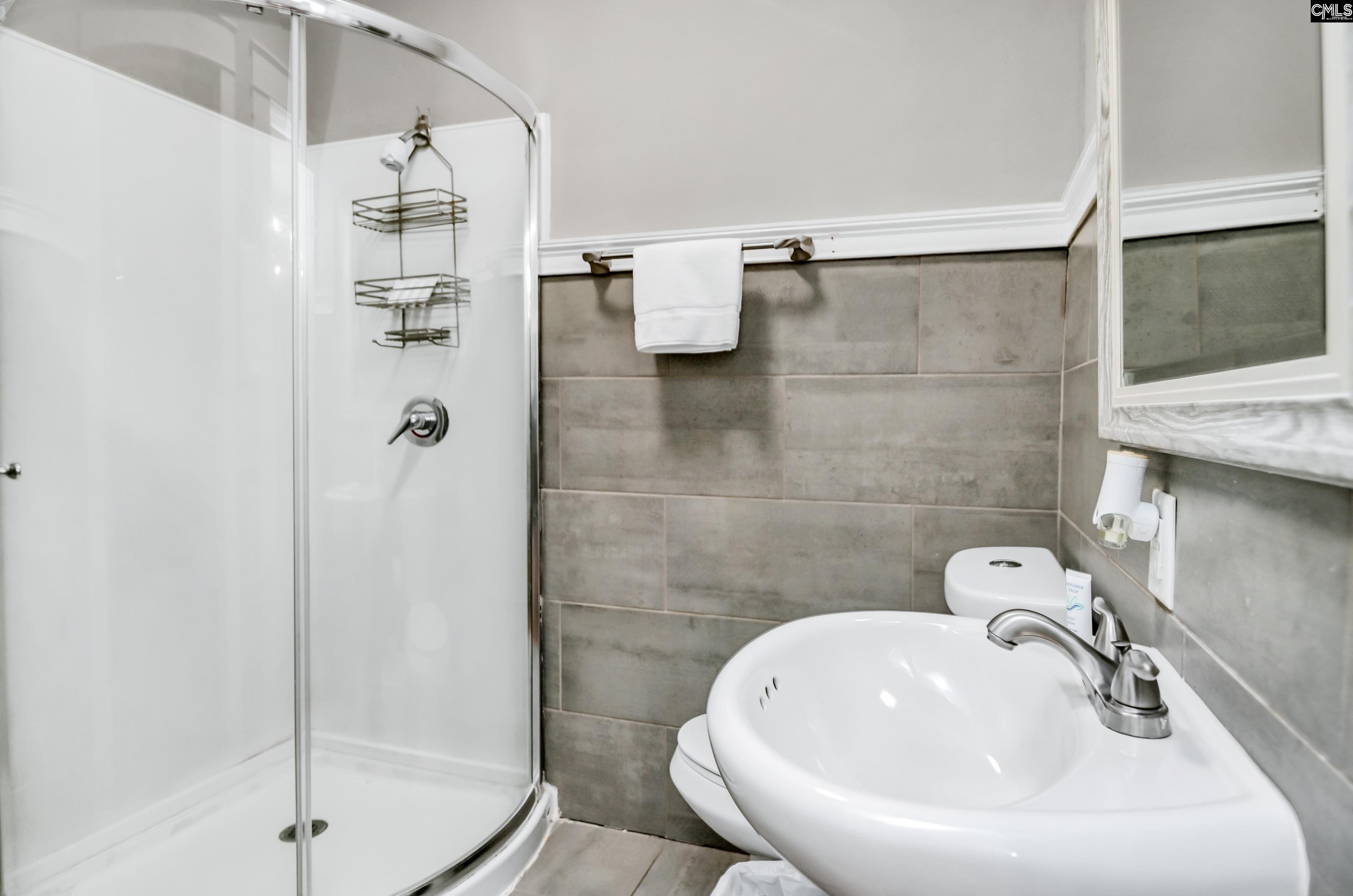 2227 Bull Street Columbia, SC 29201 - Photo 26 of 38 a bathroom with a sink a toilet and shower