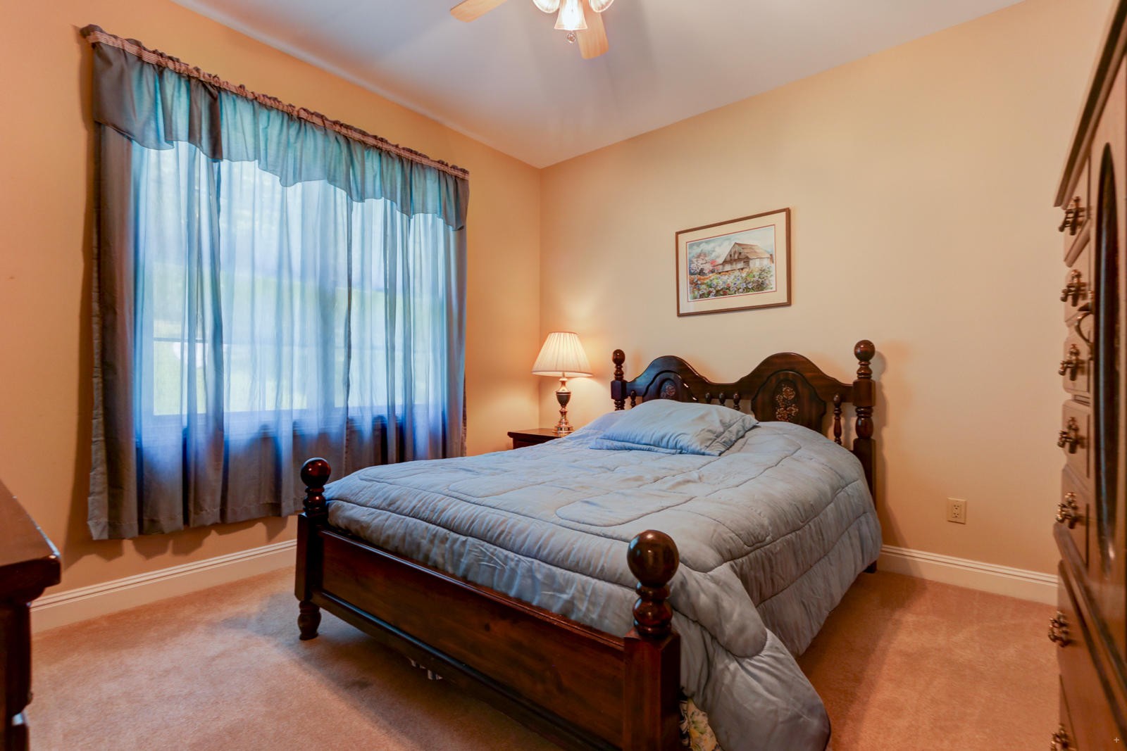 2300 Matlock Bend Road Loudon, TN 37774 - Photo 22 of 39 a bed sitting in a bedroom next to a window and a chandelier