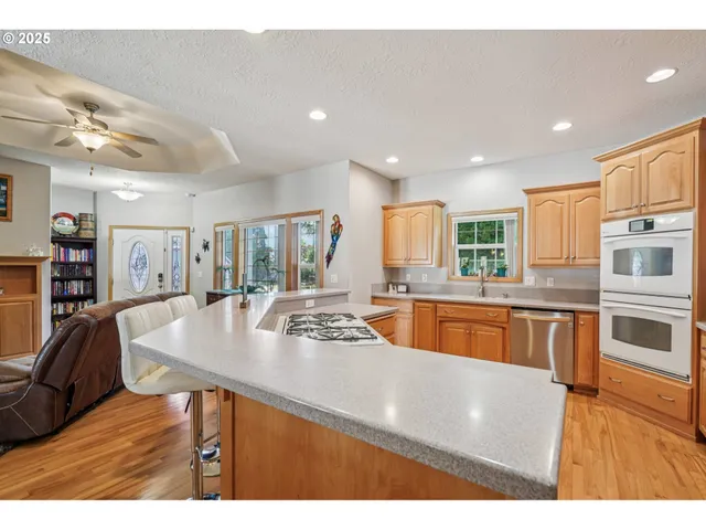 a kitchen with stainless steel appliances granite countertop a sink and a refrigerator