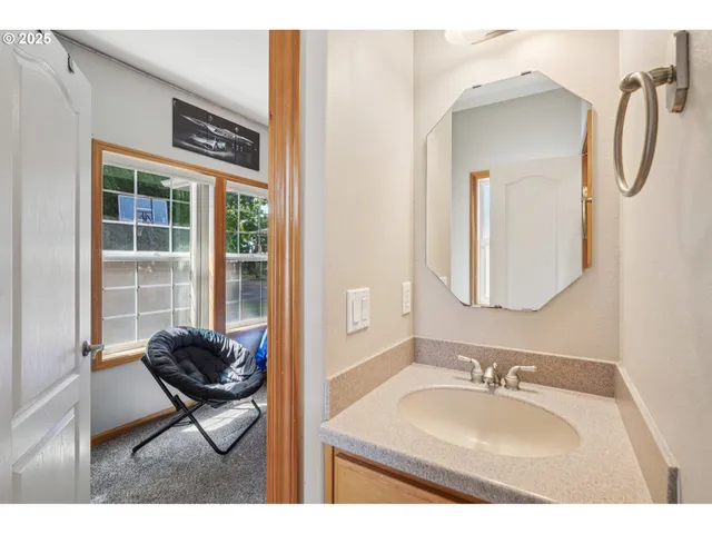 a bathroom with a sink vanity and a mirror