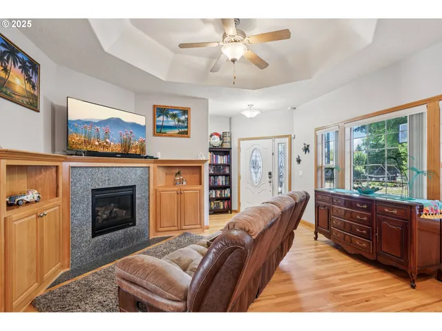a living room with furniture a fireplace and a flat screen tv