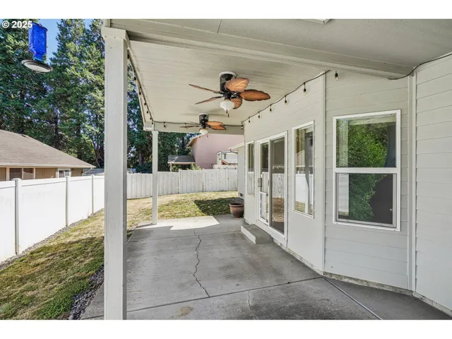a view of a house with backyard and porch