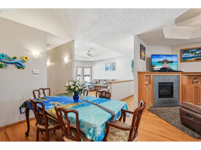 a view of a dining room with furniture and a fireplace