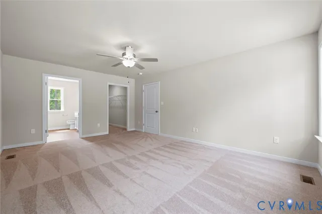 a bathroom with a granite countertop toilet sink and mirror