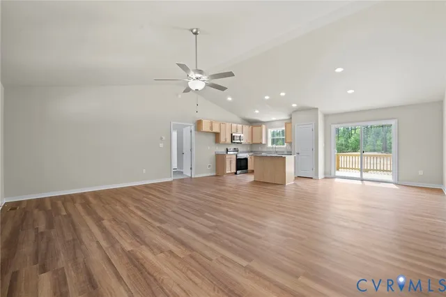 a kitchen with granite countertop wooden floors a stove and a refrigerator