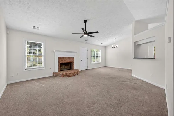 a view of a big room with a ceiling fan and a window