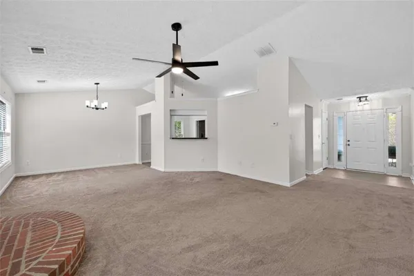 a view of an empty room with a window