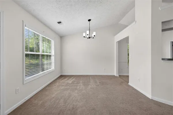 a view of a livingroom with a ceiling fan and window