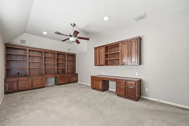 a view of an empty room with a ceiling fan