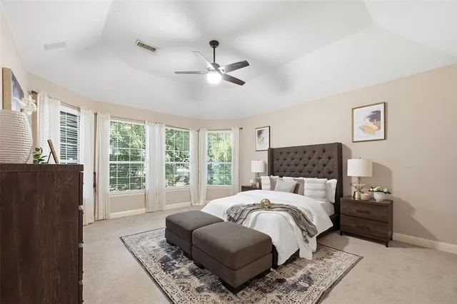 a bedroom with a large bed and a window