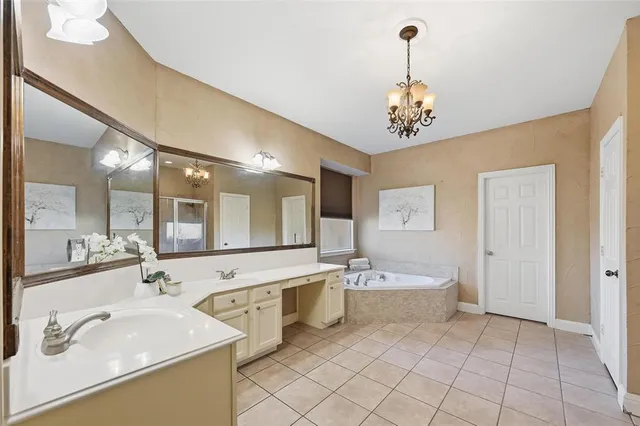 a spacious bathroom with a sink double vanity and a mirror