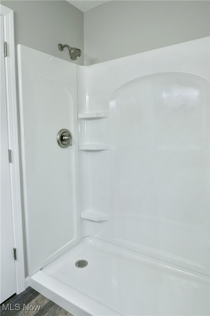2474 Johnny Cake Road Southeast Warren, OH 44484 - Photo 29 of 50 Bathroom with a textured ceiling and walk in shower