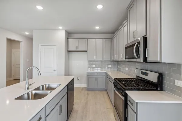 a kitchen that has a sink and a stove