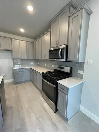 a kitchen with a stove and a sink