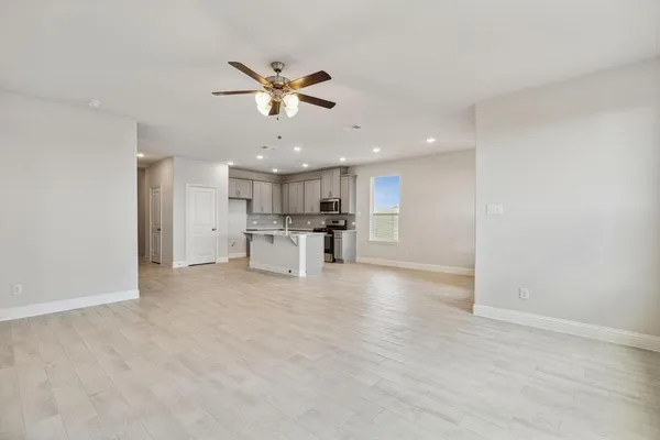 a view of a kitchen with a sink and wooden floor