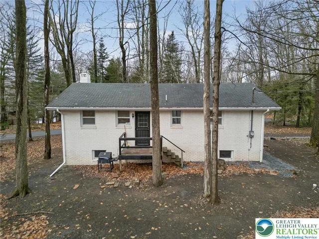 a view of a house with a yard and sitting area