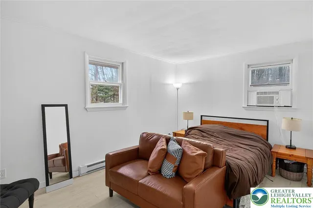 a bedroom with furniture and a window