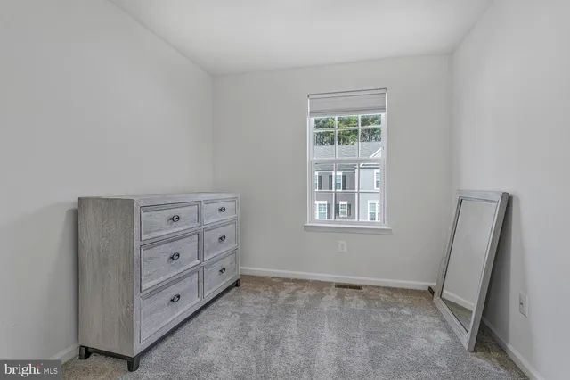 a bedroom with a large bed and a large window