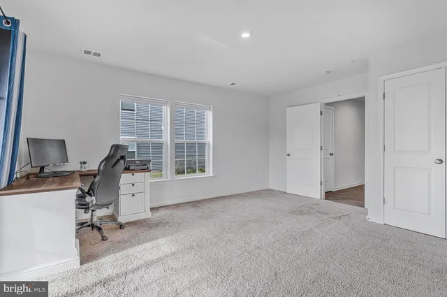 a view of a livingroom with furniture and a flat screen tv