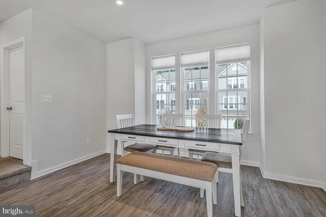 a living room with wooden floor and a table