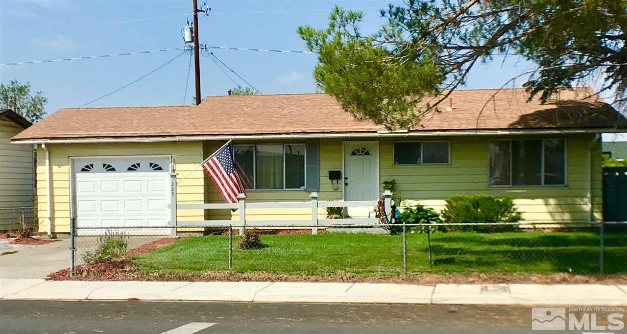 1225 Manhattan Street Reno, NV 89512 - Photo 1 of 19 a front view of a house with a garden and plants