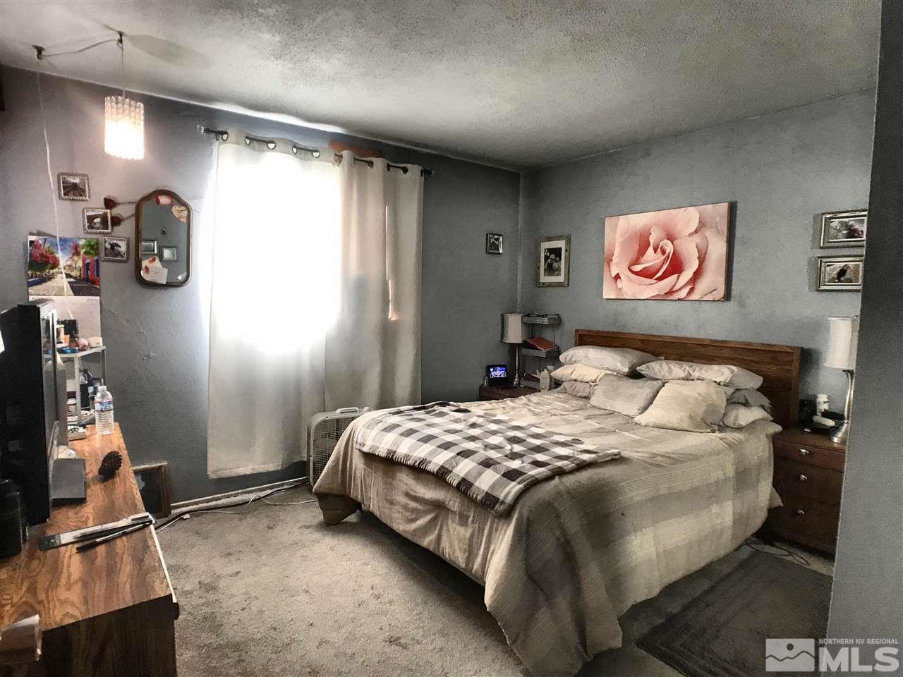 1225 Manhattan Street Reno, NV 89512 - Photo 14 of 19 a bedroom with a bed and a window
